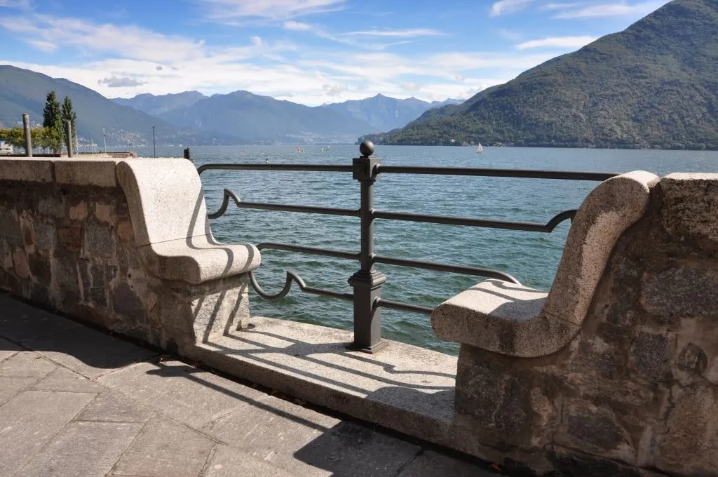 View of Lake Garda hills from the pier under a cloudy sky